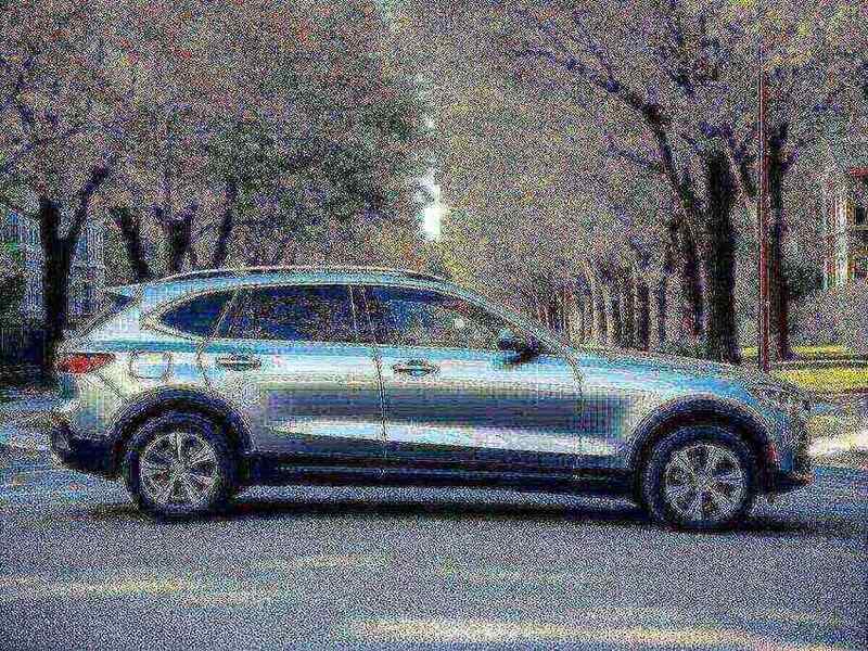A modern SUV on a tree-lined Massachusetts street