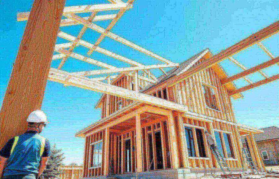 Wooden framing of a new home under construction on a bright sunny day