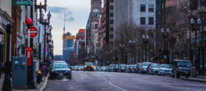 cars parked on a street with one car driving towards us