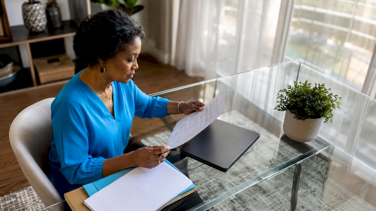 Woman reviewing homeowners insurance documents